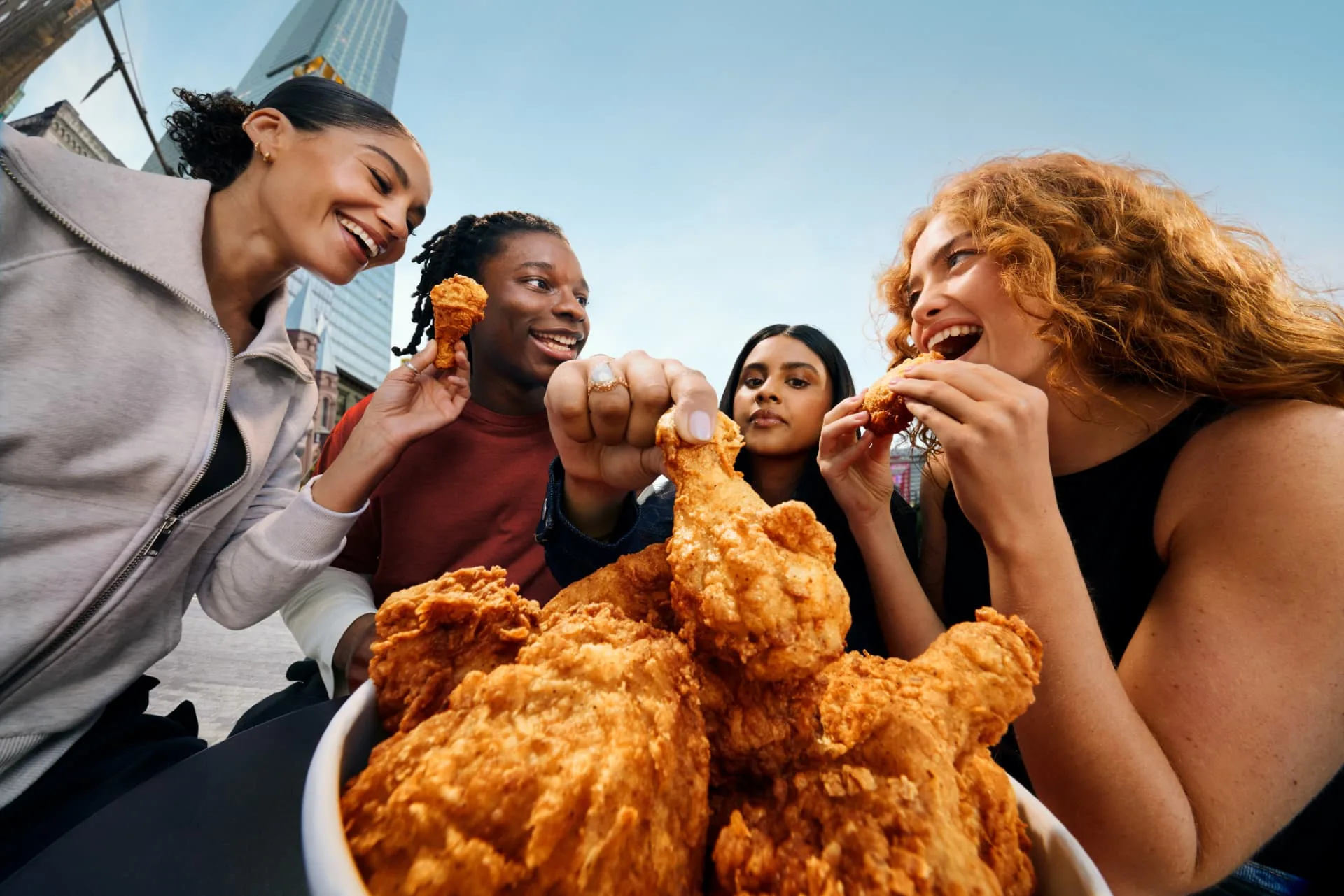 Friends sharing a bucket of Original Recipe chicken